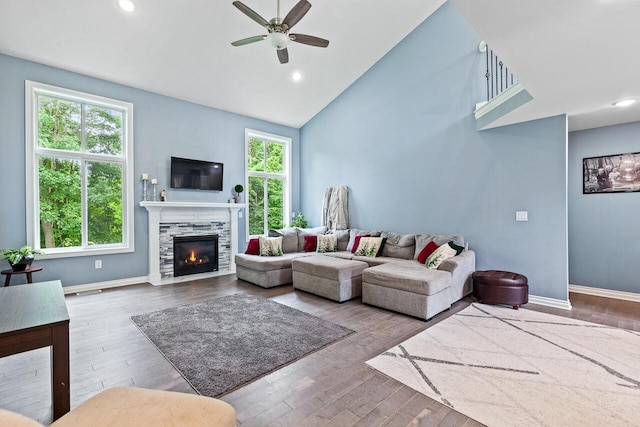 living room featuring a healthy amount of sunlight, high vaulted ceiling, and wood-type flooring