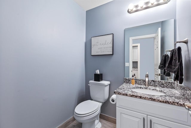 bathroom featuring hardwood / wood-style flooring, vanity, and toilet