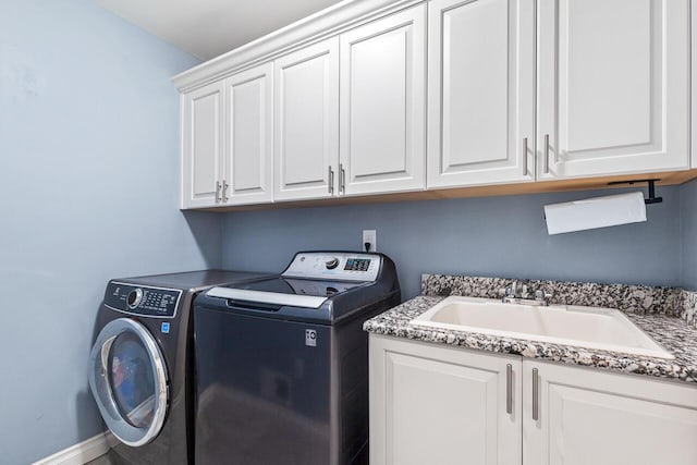 clothes washing area featuring cabinets, separate washer and dryer, and sink