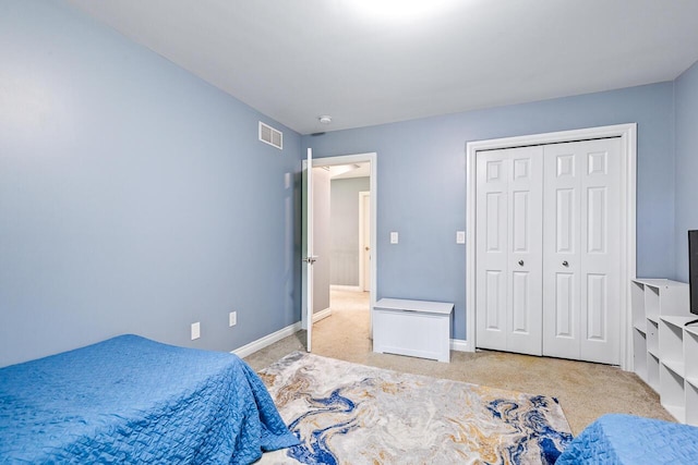 bedroom featuring light carpet and a closet