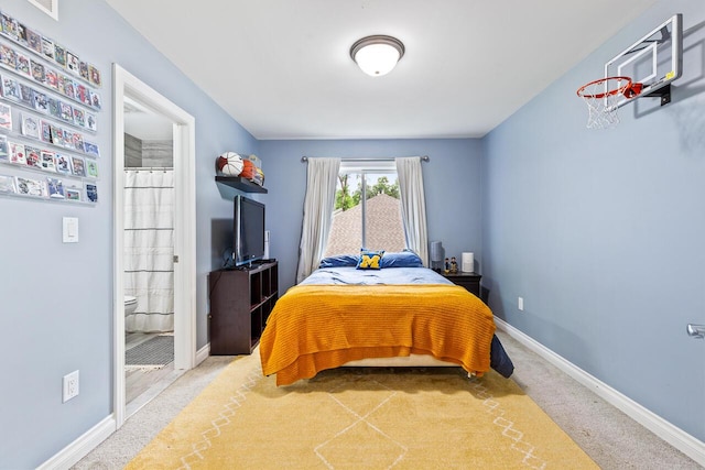 bedroom featuring carpet floors and connected bathroom