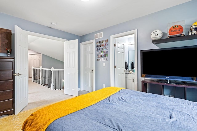 carpeted bedroom with ensuite bath