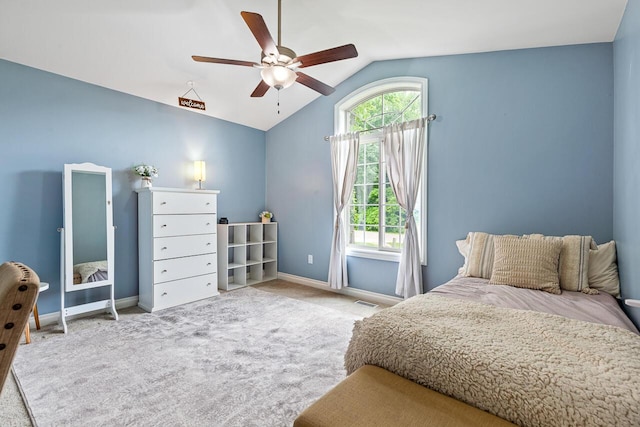 carpeted bedroom with ceiling fan and vaulted ceiling