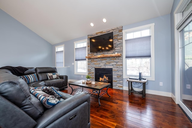 living room with a fireplace, dark hardwood / wood-style floors, vaulted ceiling, and plenty of natural light