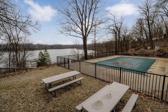 view of pool featuring a water view and a patio area