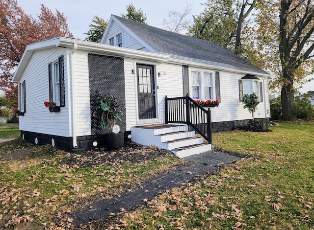 view of front of home with central AC unit and a front lawn