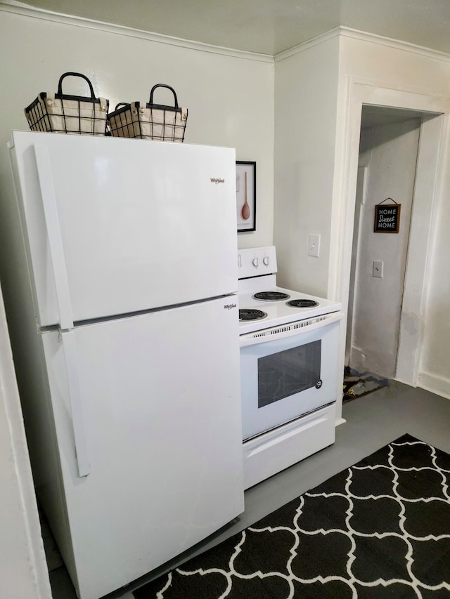 kitchen with white appliances and concrete flooring