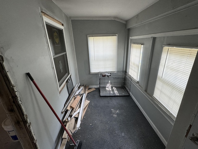 unfurnished sunroom featuring lofted ceiling