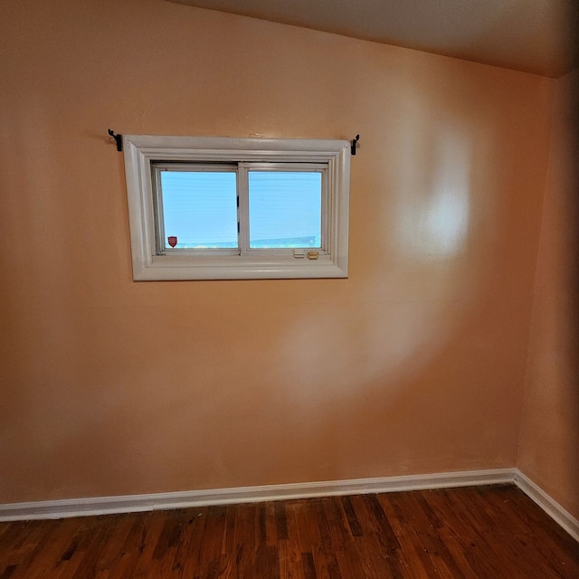 spare room with dark wood-type flooring