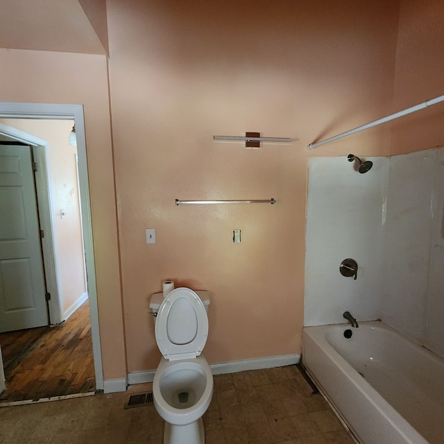 bathroom with toilet and  shower combination