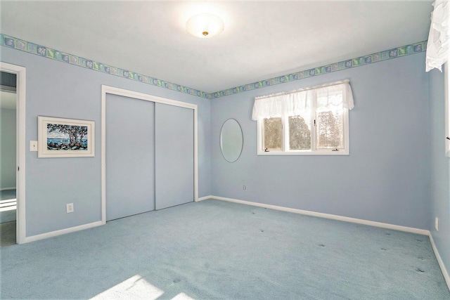 unfurnished bedroom featuring carpet flooring and a closet