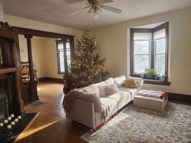 living room with wood-type flooring and ceiling fan