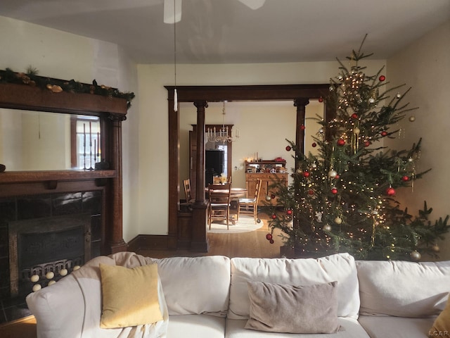 living room featuring hardwood / wood-style flooring and a tile fireplace