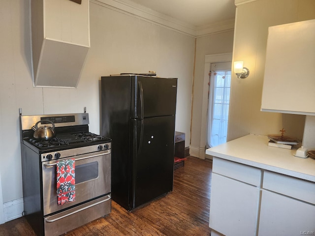 kitchen featuring gas stove, black fridge, ornamental molding, dark hardwood / wood-style flooring, and white cabinets