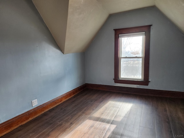 additional living space featuring hardwood / wood-style flooring and vaulted ceiling