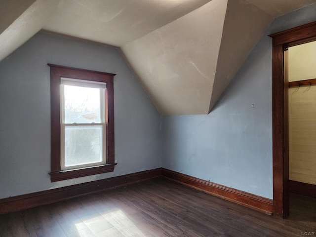 bonus room featuring dark hardwood / wood-style flooring and vaulted ceiling