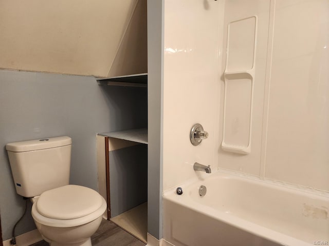 bathroom featuring tub / shower combination and toilet