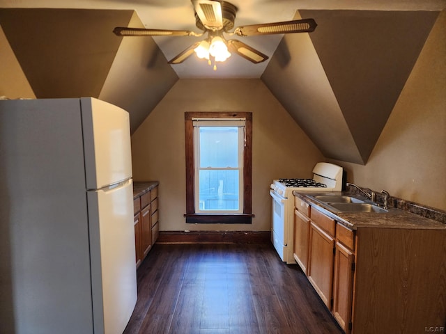 kitchen featuring vaulted ceiling, sink, dark hardwood / wood-style flooring, ceiling fan, and white appliances