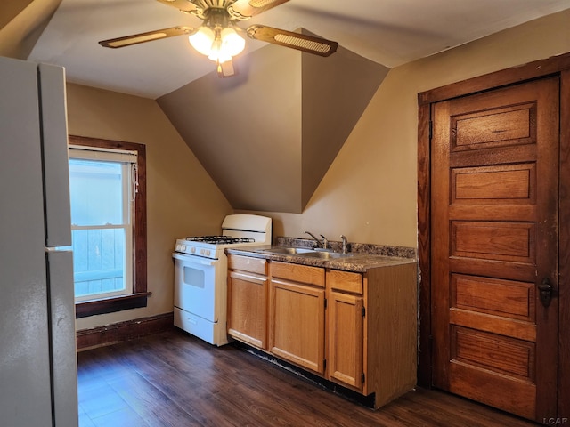 kitchen featuring dark hardwood / wood-style floors, lofted ceiling, sink, and white appliances