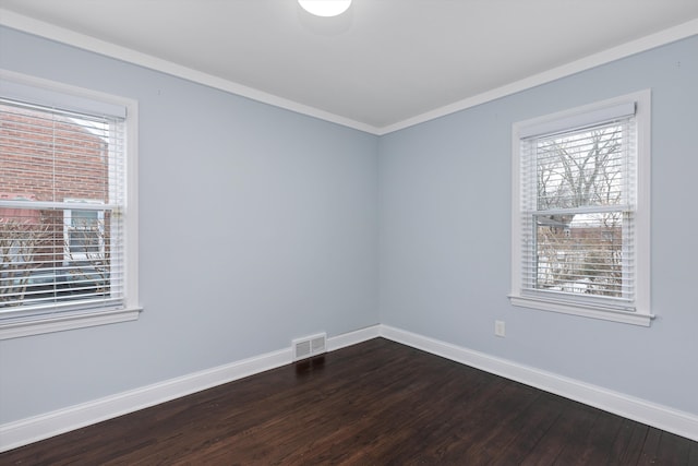 unfurnished room featuring crown molding and dark wood-type flooring