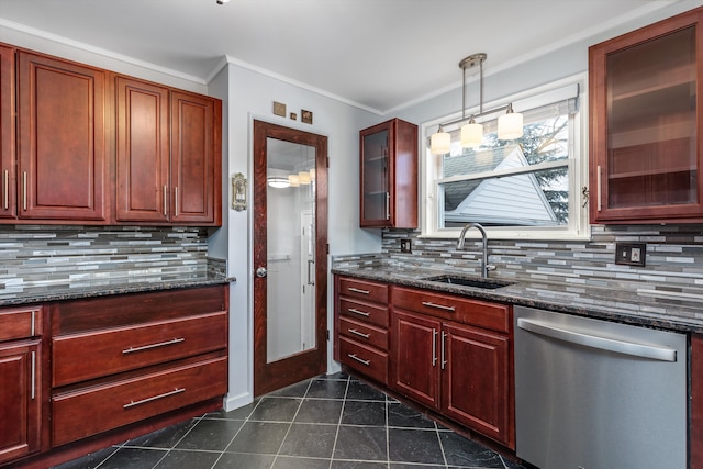 kitchen with dark stone countertops, sink, stainless steel dishwasher, and decorative light fixtures