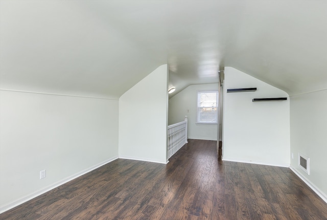 bonus room featuring vaulted ceiling and dark hardwood / wood-style flooring