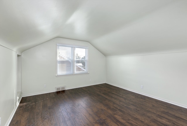 bonus room with lofted ceiling and dark hardwood / wood-style floors