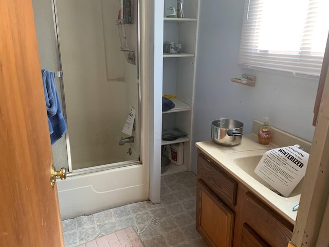 bathroom with enclosed tub / shower combo and vanity