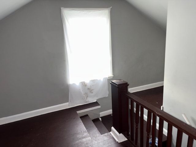 bonus room featuring dark hardwood / wood-style flooring and vaulted ceiling