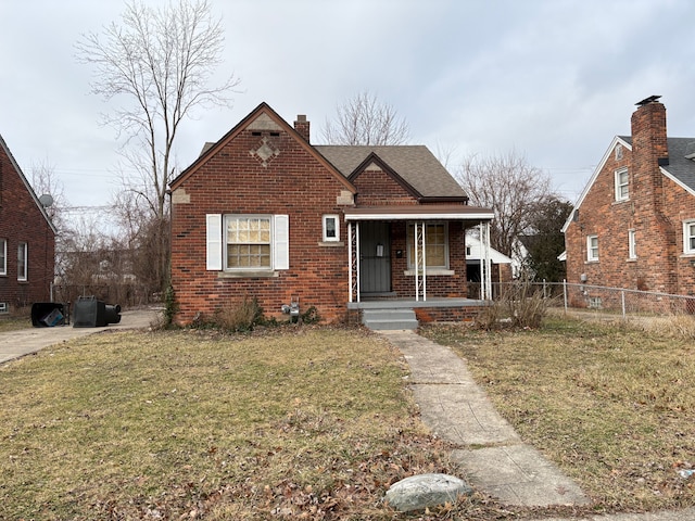 bungalow-style house with a front lawn and covered porch