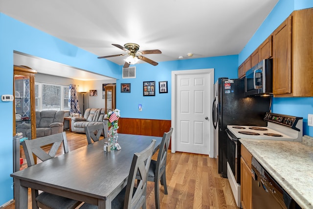 dining space featuring ceiling fan and light wood-type flooring