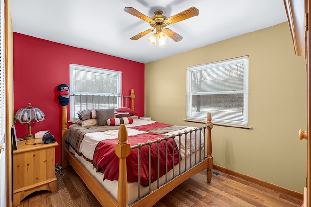 bedroom with ceiling fan and wood-type flooring