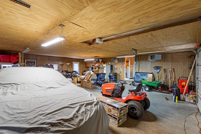 garage with a garage door opener, wooden walls, wooden ceiling, and an AC wall unit