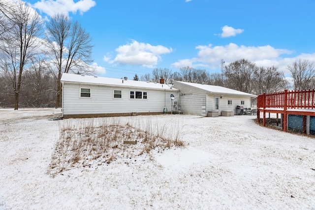 snow covered property featuring a deck