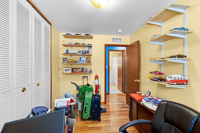 office with light hardwood / wood-style flooring