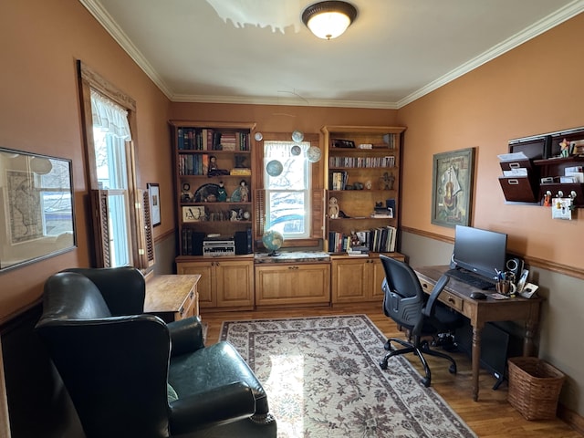 home office with ornamental molding, plenty of natural light, and light hardwood / wood-style floors