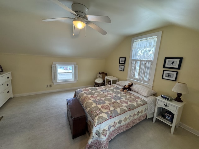 carpeted bedroom featuring multiple windows, vaulted ceiling, and ceiling fan