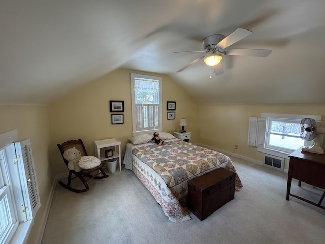 bedroom featuring vaulted ceiling, light colored carpet, and ceiling fan