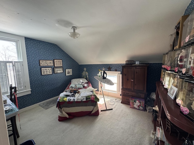 carpeted bedroom featuring multiple windows and vaulted ceiling