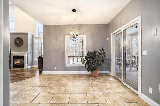 unfurnished dining area featuring light tile patterned flooring and a chandelier