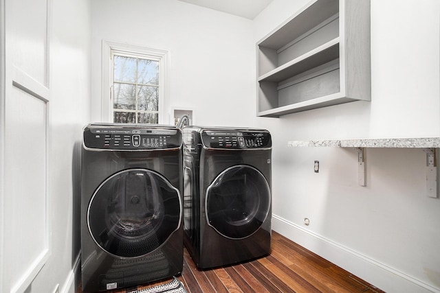 washroom featuring dark hardwood / wood-style flooring and washer and clothes dryer