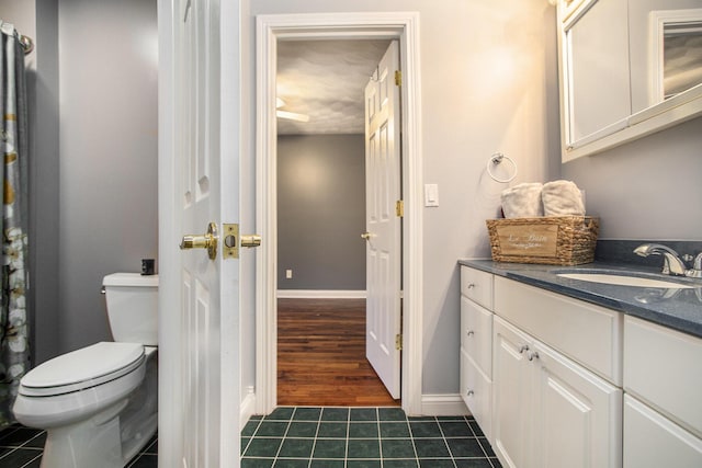 bathroom with vanity, toilet, and tile patterned flooring