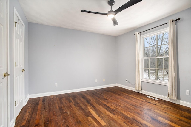 unfurnished room featuring ceiling fan, a healthy amount of sunlight, and dark hardwood / wood-style flooring