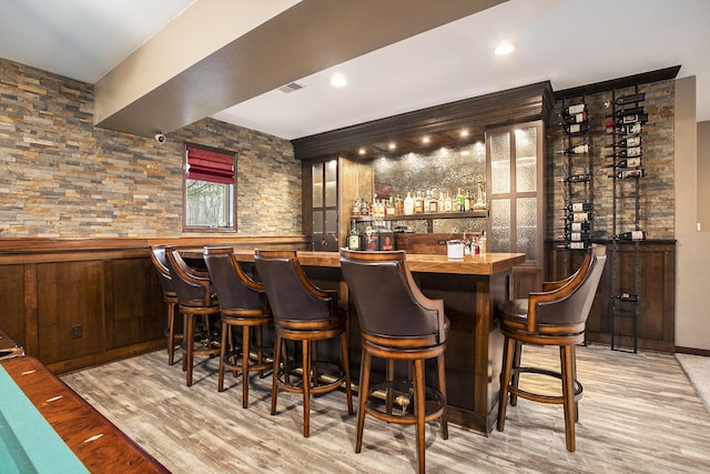 bar with light wood-type flooring