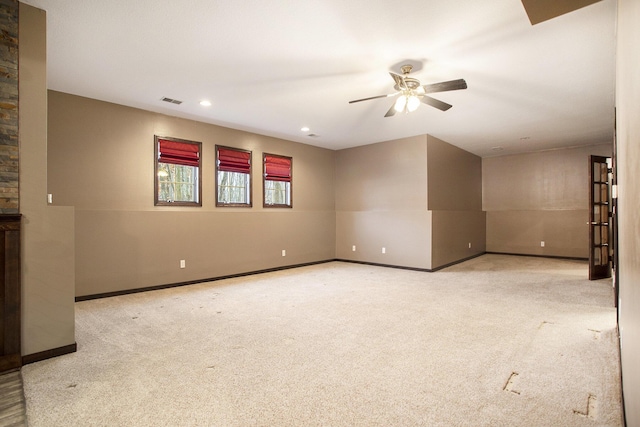 carpeted empty room featuring ceiling fan