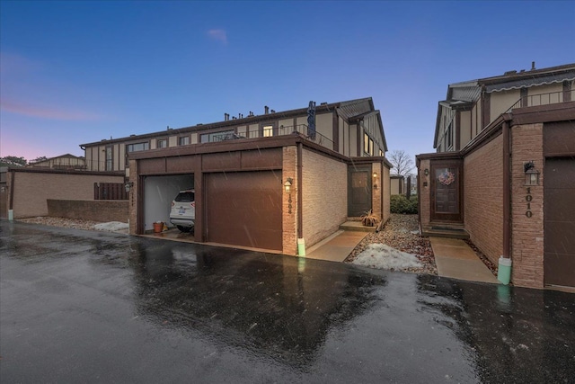 exterior space featuring a garage and a balcony