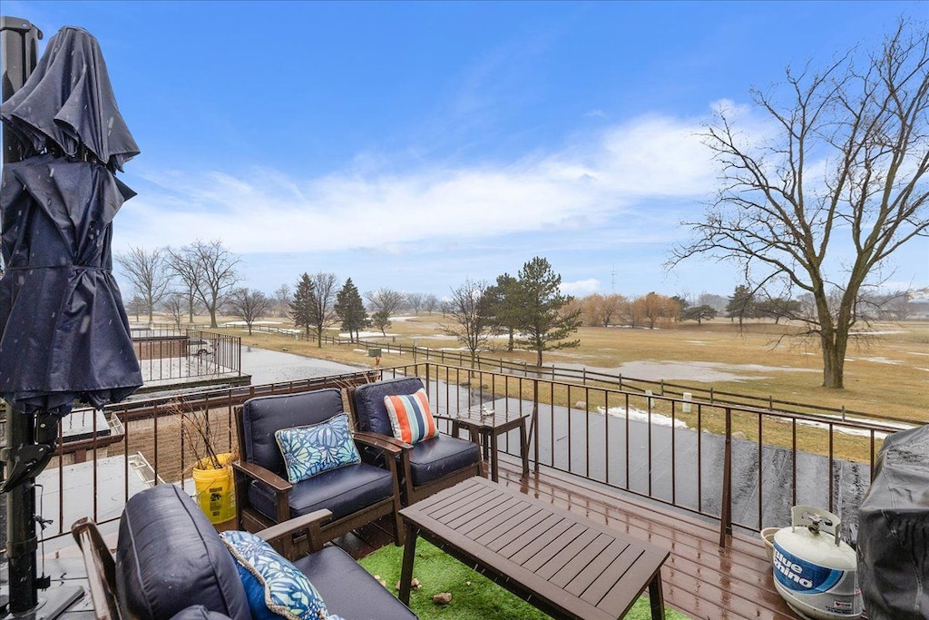 wooden terrace featuring a rural view