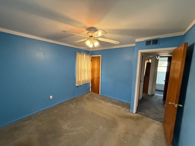 unfurnished bedroom with ceiling fan, a closet, crown molding, and carpet floors