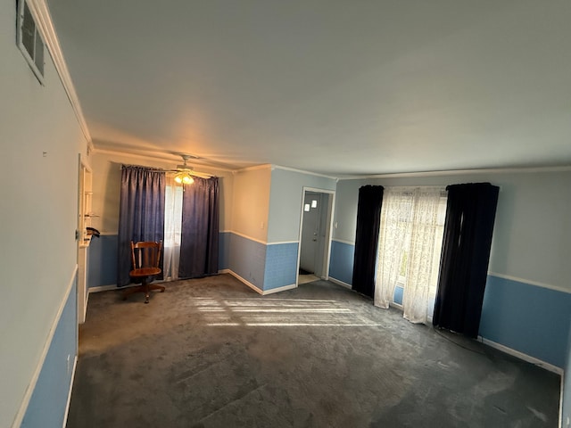 carpeted spare room with crown molding and ceiling fan