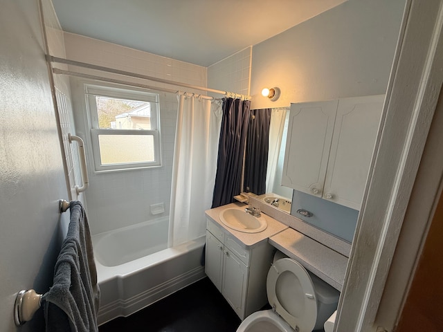 full bathroom featuring toilet, shower / bath combo with shower curtain, and vanity